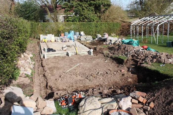 Larger greenhouse was removed but existing concrete base was kept to reduce the amount of work to construct the new base. The new greenhouse was wider therefore new retaining walls were built