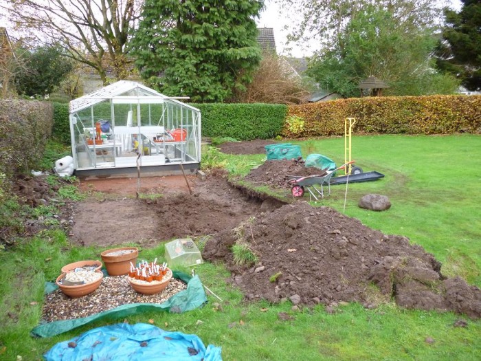 There is a slope to the garden so the next job was digging down to level the site. The larger greenhouse was kept in place until the main area was level.